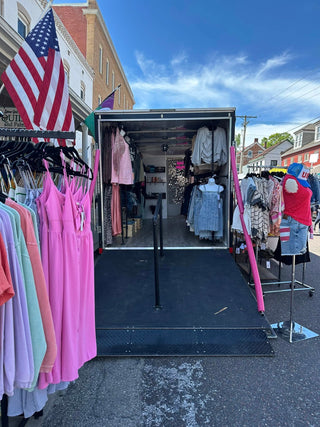 Exterior view of boutique trailer set up at an event