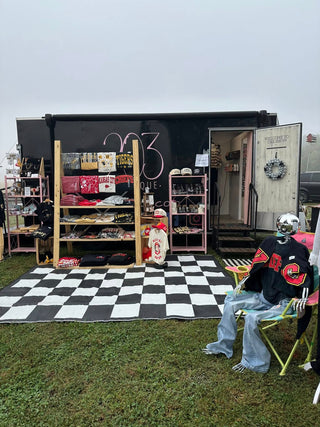 Exterior view of boutique trailer set up at an event